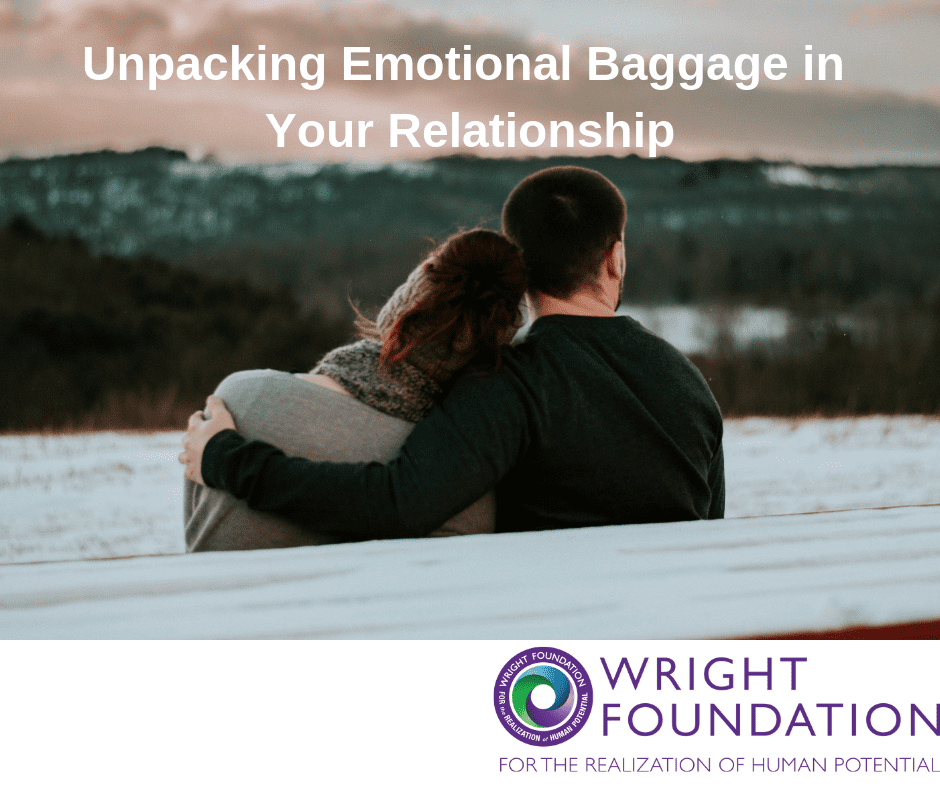 A couple cuddle as they take in the view. Unpacking emotional baggage in your relationship brings us closer to the ones we love. 